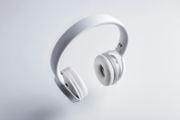 Floating white wireless headphones on a minimalist white background. Perfect for tech promotions.