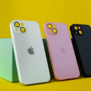 Three colorful smartphone cases displayed on a vibrant yellow background with green box for modern design.