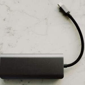 Sleek power bank with USB-C cable on a marble surface, ideal for travel tech needs.